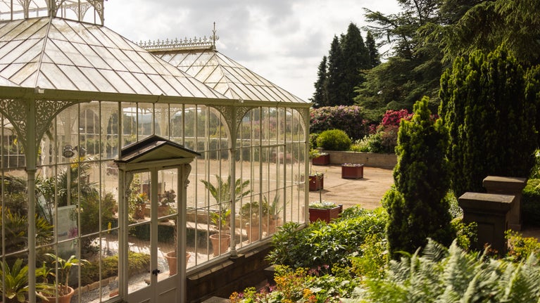 The outside of the Victorian Conservatory with flowers in the background